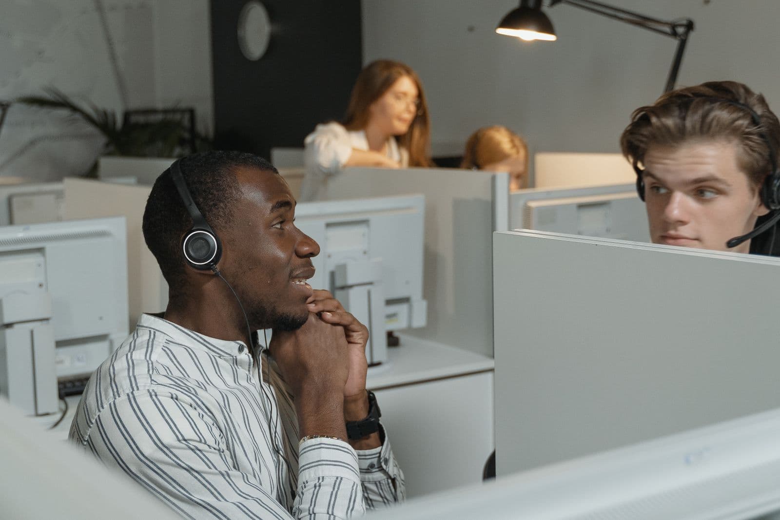 Customer service team coordinating calls from a professional office