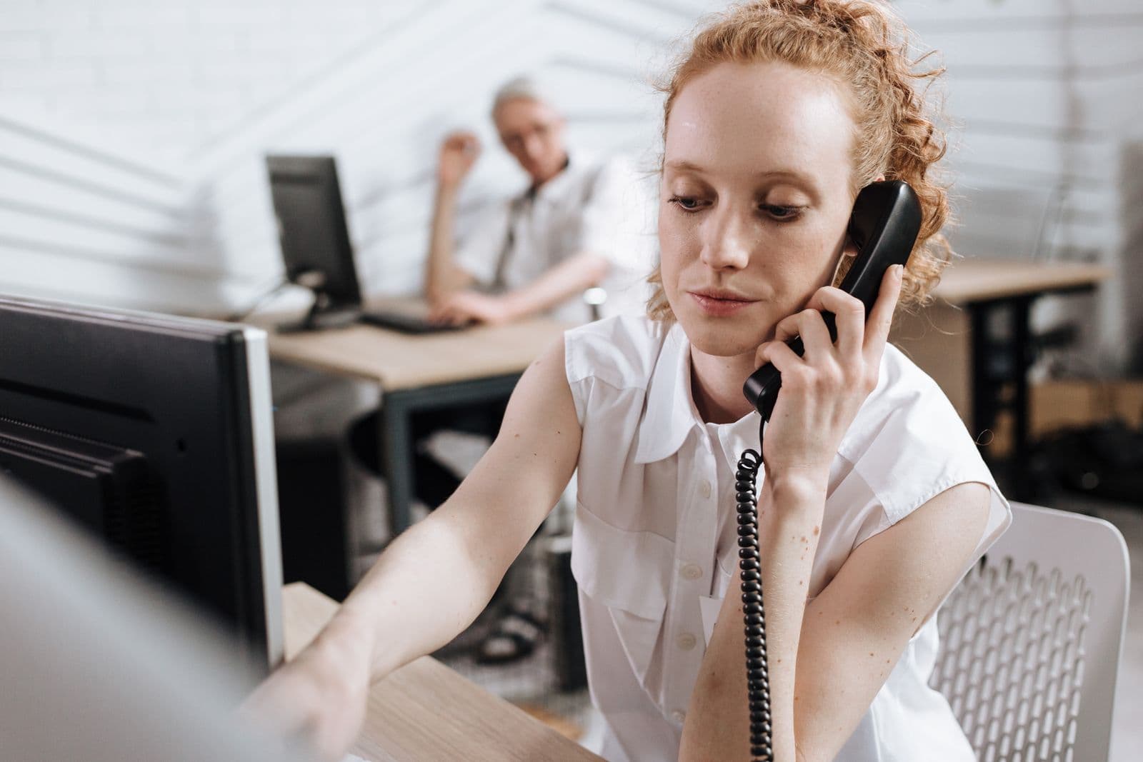 Outbound calling specialist speaking with a customer by telephone