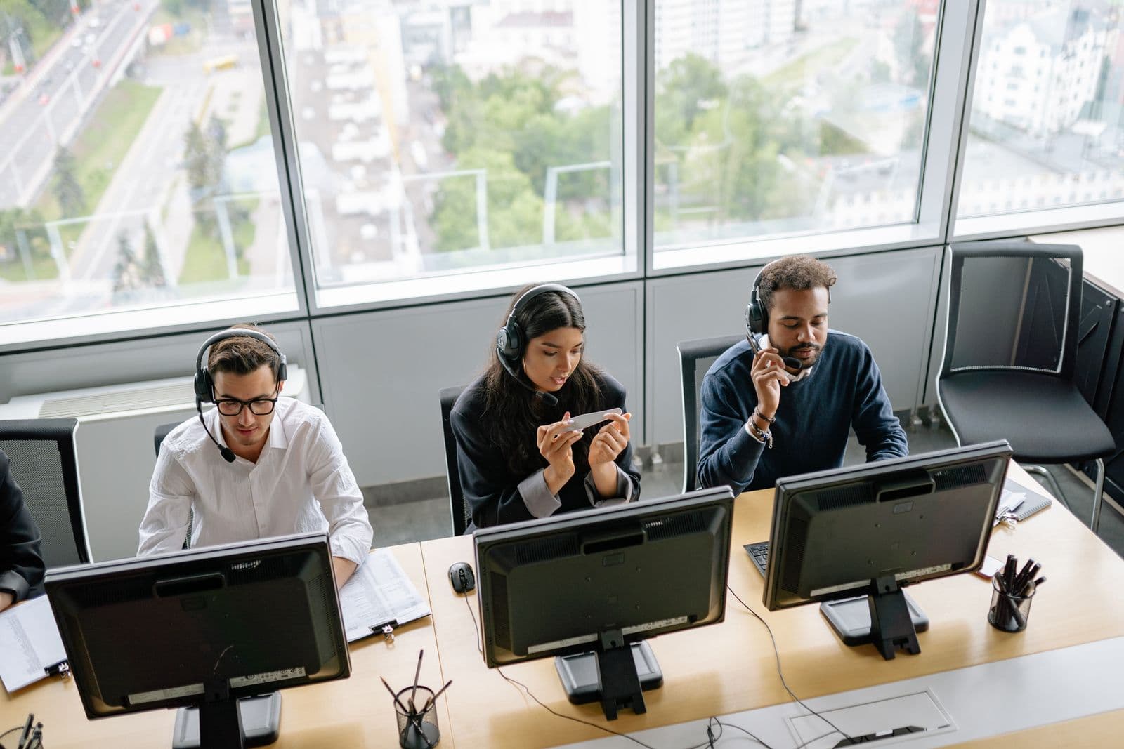 Sales representatives managing phone conversations from an office